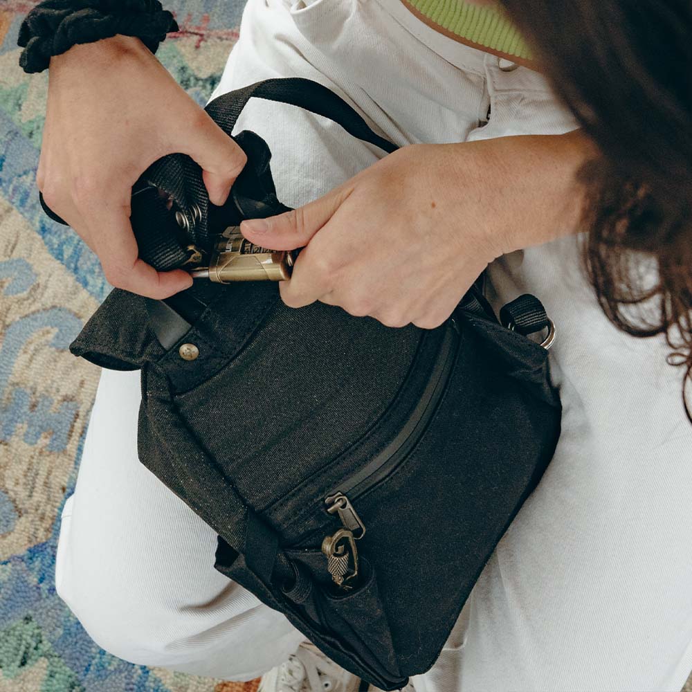 An image of a person holding Loctote's Mini Cinch Backpack